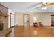 Spacious living room with a brick fireplace, hardwood floors, and multiple doorways leading to other rooms at 370 Merrydale Dr, Fayetteville, GA 30215
