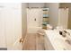 Bathroom featuring a shower-tub combo, white fixtures, and linoleum flooring at 1417 Se Pickett'S Ct, Conyers, GA 30013