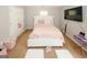 Bedroom featuring a white upholstered bed frame, carpeting, and natural light at 1417 Se Pickett'S Ct, Conyers, GA 30013