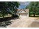 Spacious home featuring an attached garage, a long driveway, and a well-maintained lawn at 1417 Se Pickett'S Ct, Conyers, GA 30013