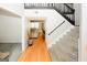 Inviting foyer with hardwood floors, a staircase with black railings, and views into the living spaces at 1417 Se Pickett'S Ct, Conyers, GA 30013