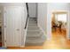 Bright foyer featuring hardwood floors, a carpeted staircase, and an open doorway to the dining area at 1417 Se Pickett'S Ct, Conyers, GA 30013