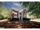 Attractive two-story home featuring brick accents, siding, a manicured front yard, and an attached garage at 1417 Se Pickett'S Ct, Conyers, GA 30013