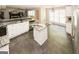 Bright kitchen with marble island and black backsplash; modern stainless steel appliances at 1417 Se Pickett'S Ct, Conyers, GA 30013