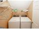 Laundry room with washer, dryer, and storage shelving at 1417 Se Pickett'S Ct, Conyers, GA 30013