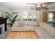 Cozy living room with a large sectional sofa, hardwood floors, a fireplace, and ample natural light at 1417 Se Pickett'S Ct, Conyers, GA 30013