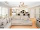 Bright living room view into modern, updated kitchen with bar seating and neutral color palette at 1417 Se Pickett'S Ct, Conyers, GA 30013