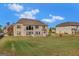 Grassy backyard of a brick home with large windows, offering plenty of natural light and outdoor enjoyment at 3705 Royer Ln, Hampton, GA 30228