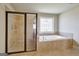 Luxurious bathroom with a glass-enclosed shower and a stylish window above the jetted tub for a spa-like experience at 3705 Royer Ln, Hampton, GA 30228