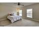 Cozy bedroom with neutral walls, carpet, ceiling fan and light filled windows at 3705 Royer Ln, Hampton, GA 30228