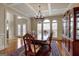 Elegant dining area with hardwood flooring, large windows, a coffered ceiling, chandelier and classic furniture at 3705 Royer Ln, Hampton, GA 30228