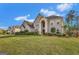 Charming brick home with arched entryway and professionally landscaped yard in a Gathering-friendly suburban community at 3705 Royer Ln, Hampton, GA 30228