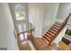 Grand two-story foyer with hardwood floors, elegant staircase, and abundant natural light, perfect for welcoming guests at 3705 Royer Ln, Hampton, GA 30228