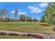 Scenic view of the golf course with lush green fairways, mature trees, and residential properties in the background at 3705 Royer Ln, Hampton, GA 30228