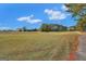 Expansive green space under a bright blue sky, ideal for recreation and enjoying nature at 3705 Royer Ln, Hampton, GA 30228