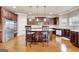 Spacious kitchen with an island, stainless steel appliances, brown cabinets and hardwood floors provides functionality at 3705 Royer Ln, Hampton, GA 30228