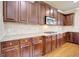 Beautiful kitchen with dark cabinets, granite countertops, stainless steel appliances, tile backsplash and hardwood floors at 3705 Royer Ln, Hampton, GA 30228