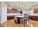A spacious kitchen features stainless appliances, stone countertops, and a central island with seating at 3705 Royer Ln, Hampton, GA 30228