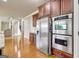 Modern kitchen features stainless steel appliances, hardwood floors, and ample cabinet space with an open design at 3705 Royer Ln, Hampton, GA 30228