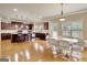An open-concept kitchen and dining area with wood floors and ample natural light create a perfect space for entertaining at 3705 Royer Ln, Hampton, GA 30228