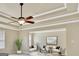 Bright living room with tray ceilings, ceiling fan, and neutral tones, creating a welcoming and relaxing atmosphere at 3705 Royer Ln, Hampton, GA 30228