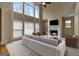 An elegant living room features large windows, a fireplace, and a neutral color palette at 3705 Royer Ln, Hampton, GA 30228
