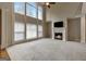 An elegant living room features large windows, a fireplace, and a neutral color palette at 3705 Royer Ln, Hampton, GA 30228