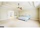 Spacious main bedroom featuring a tray ceiling, ceiling fan, and an ensuite bathroom for added privacy and convenience at 3705 Royer Ln, Hampton, GA 30228