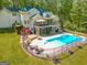 Aerial view of a home with a large backyard, inground pool, a deck and mature trees at 140 Horton Creek Trl, Brooks, GA 30205