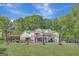 Expansive backyard featuring a pool and a two-story home with a deck at 140 Horton Creek Trl, Brooks, GA 30205