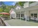 A covered back deck with comfortable seating, a grill, and lovely views at 140 Horton Creek Trl, Brooks, GA 30205