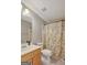 Neutral bathroom with tile flooring and a shower/tub combo with a leaf-patterned curtain at 140 Horton Creek Trl, Brooks, GA 30205