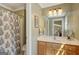 Well-lit bathroom with a shower, vanity, and a decorative mirror at 140 Horton Creek Trl, Brooks, GA 30205