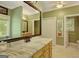Bathroom featuring a granite countertop, bronze fixtures, and decorative mirror at 140 Horton Creek Trl, Brooks, GA 30205