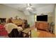 Cozy bedroom with hardwood floors, a ceiling fan, natural light and a vintage desk at 140 Horton Creek Trl, Brooks, GA 30205