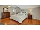 Bright bedroom with wood flooring, and a comfortable bed flanked by nightstands at 140 Horton Creek Trl, Brooks, GA 30205