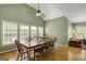 Open dining area with hardwood floors, a ceiling fan, and many windows at 140 Horton Creek Trl, Brooks, GA 30205