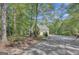 Charming home exterior featuring a circular driveway and lush greenery at 140 Horton Creek Trl, Brooks, GA 30205