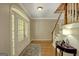 Bright foyer with hardwood floors, staircase, and French doors, offering a grand entrance at 140 Horton Creek Trl, Brooks, GA 30205