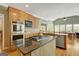 Kitchen island with cooktop, granite countertop and stainless dishwasher at 140 Horton Creek Trl, Brooks, GA 30205