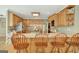 Kitchen with hardwood floors, granite counters, wood cabinets and bar stool seating at 140 Horton Creek Trl, Brooks, GA 30205