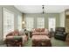 Cozy living room with large windows and comfortable seating arrangement at 140 Horton Creek Trl, Brooks, GA 30205