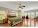 Bright bedroom with large windows, hardwood floors, and a ceiling fan at 140 Horton Creek Trl, Brooks, GA 30205