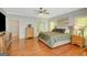 Sun-filled bedroom with hardwood floors, neutral colors, and ensuite bathroom at 140 Horton Creek Trl, Brooks, GA 30205