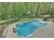 An in-ground swimming pool surrounded by a lush, fenced backyard at 140 Horton Creek Trl, Brooks, GA 30205