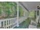 Relaxing covered porch with rocking chairs and views of the surrounding woods at 140 Horton Creek Trl, Brooks, GA 30205