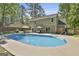 Stunning backyard with in-ground pool, fountain, patio, and lush landscaping creates a private oasis at 308 Summer Pl, Peachtree City, GA 30269