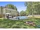 Expansive backyard features a pool, fire pit, outdoor seating, and lush greenery perfect for entertaining at 308 Summer Pl, Peachtree City, GA 30269