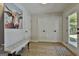 Bright hallway with a white cushioned bench, double doors, and a vibrant painting at 308 Summer Pl, Peachtree City, GA 30269