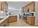 Open kitchen with stainless steel appliances and light wood cabinets, great for entertaining at 308 Summer Pl, Peachtree City, GA 30269